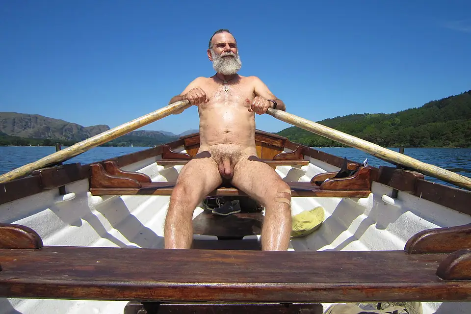A naturist rows on Coniston Water in England's Lake District